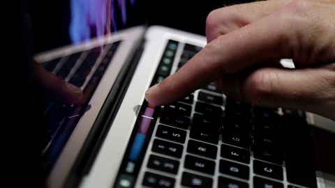 FILE - In this Thursday, Oct. 27, 2016, file photo, a guest looks at the Touch Bar on a MacBook computer shown in a demo room following the announcement of new products at Apple headquarters, in Cupertino, Calif. Higher-end models of Apple’s MacBook Pro now come with a narrow touch screen above the regular keyboard for quick access to common settings and tasks. (AP Photo/Marcio Jose Sanchez, File)