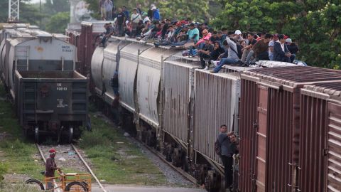 Central American migrants climb ride a train during their journey toward the U.S.-Mexico border in Ixtepec, Mexico, Saturday, July 12, 2014. The number of unaccompanied minors detained on the U.S. border has more than tripled since 2011. Children are also widely believed to be crossing with their parents in rising numbers.(AP Photo/Eduardo Verdugo)