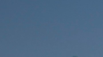 California Highway Patrol officer Matthew Musselmann uses a lidar gun for speed detection along Interstate 5 freeway, Thursday, April 23, 2020, in Anaheim, Calif. The CHP is issuing a lot more tickets to motorists where lanes are wide open during the coronavirus pandemic. From March 19, when the stay-at-home order began, through April 19, officers issued 87% more citations to drivers suspected of speeding in excess of 100 mph. That's compared to the same period last year. The jump in speeding tickets coincides with a 35% decline in traffic volume. (AP Photo/Chris Carlson)
