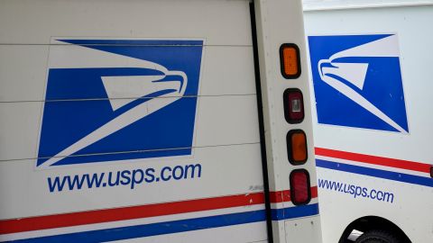 FILE - U.S. Postal Service delivery vehicles are parked outside a post office in Boys Town, Neb., Aug. 18, 2020. (AP Photo/Nati Harnik, File)