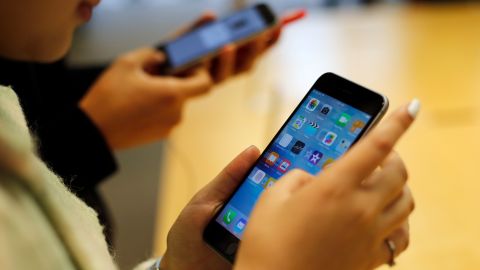 Customers try out a new Apple iPhone 6S at an Apple store on Chicago's Magnificent Mile, Friday, Sept. 25, 2015, in Chicago. (AP Photo/Kiichiro Sato)