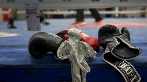 FILE - In this Friday, April 29, 2016 file photo, boxing gloves lie on a boxing ring as boxers work out at El Rayo boxing gym in Madrid, Spain. Journeymen fighters like Jamie Quinn regularly rack up losses in British boxing. They’re hired to fight up-and-comers who are unbeaten or looking to bolster their resumes. Wins are few and far between. The 30-year-old Quinn has a record of seven wins, 104 losses and two draws. He has fought and lost twice since boxing events returned from the pandemic stoppage. (AP Photo/Francisco Seco, File)