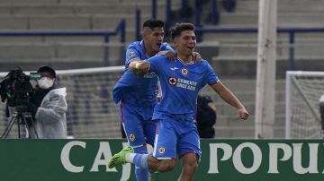 Rodrigo Huescas of Cruz Azul, right, celebrates with his teammate Carlos Antuna after scoring the opening goal against Pumas during a Mexican soccer league match in Mexico City, Sunday, Sept. 18, 2022. (AP Photo/Fernando Llano)