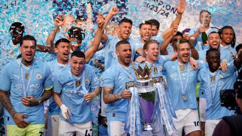 FILE - Manchester City's Kyle Walker celebrates with the Premier League trophy after the English Premier League soccer match between Manchester City and West Ham United at the Etihad Stadium in Manchester, England, Sunday, May 19, 2024. A fourth-straight Premier League title for Manchester City marks an unprecedented period of dominance by one team in English soccer. (AP Photo/Dave Thompson, File)