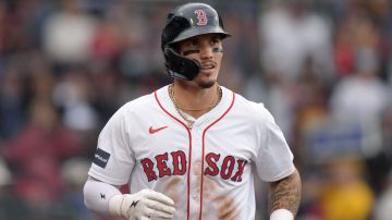 FILE - Boston Red Sox outfielder Jarren Duran, center, returns to the dugout after scoring on an error after Vaughn Grissom hit a double in the third inning of a baseball game against the Tampa Bay Rays, Sept. 29, 2024, in Boston. (AP Photo/Steven Senne, File)