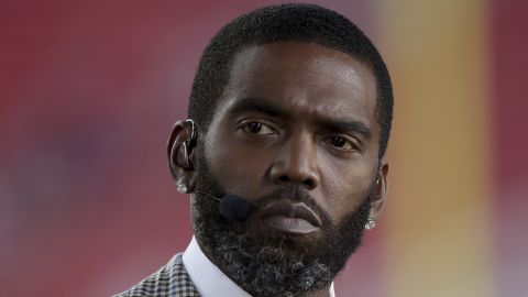 FILE - Broadcaster Randy Moss sits on the sideline before an NFL football game between the San Francisco 49ers and the Los Angeles Rams, Monday, Nov. 15, 2021, in Santa Clara, Calif. (AP Photo/Scot Tucker, File)