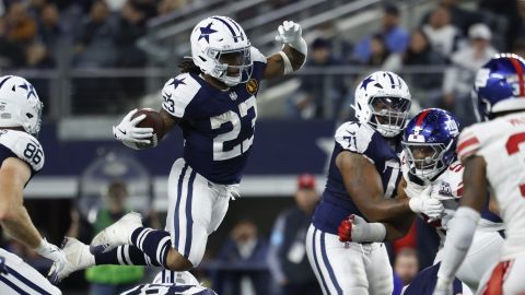 Dallas Cowboys running back Rico Dowdle (23) hurdles a defender as he carries the ball during an NFL football game against the New York Giants on Thursday, Nov. 28, 2024, in Arlington, Texas. (AP Photo/Matt Patterson)