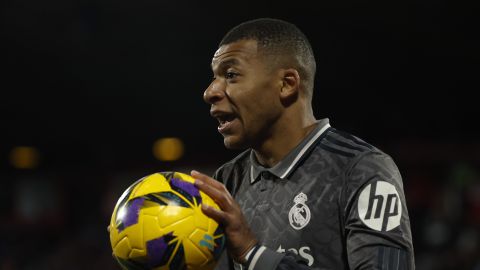 Real Madrid's Kylian Mbappe holds the ball during a Spanish La Liga soccer match between Girona and Real Madrid at the Montilivi stadium in Girona, Spain, Saturday, Dec. 7, 2024. (AP Photo/Joan Monfort)