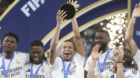 Real Madrid's Kylian Mbappe lifts the trophy after winning the Intercontinental Cup soccer final match against CF Pachuca at the Lusail Stadium in Lusail, Qatar, Wednesday, Dec. 18, 2024. Real Madrid won the game 3-0.(AP Photo/Hussein Sayed)