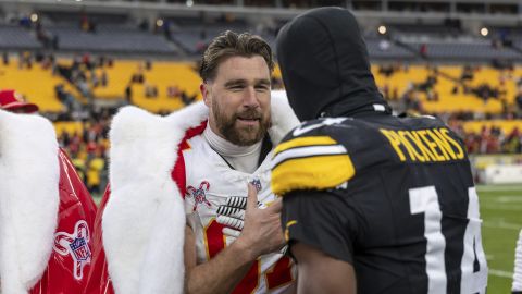 Kansas City Chiefs tight end Travis Kelce (87) and Pittsburgh Steelers wide receiver George Pickens (14) embrace after an NFL football game, Wednesday, Dec. 25, 2024, in Pittsburgh. (AP Photo/Matt Durisko)