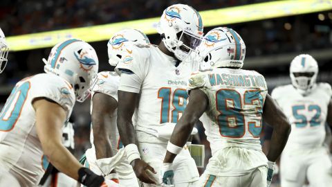 Miami Dolphins quarterback Tyler Huntley (18) celebrates a touchdown with wide receiver Malik Washington (83) during an NFL football game against the Cleveland Browns, Sunday, Dec. 29, 2024, in Cleveland. (AP Photo/Kirk Irwin)