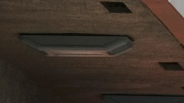 A Los Angeles Police Department officers assess an accident near downtown Los Angeles on Thursday, Oct. 6, 2016. The traffic accident left a vehicle overturned on a sidewalk and another smashed-up car in the drive-thru lane of a fast-food restaurant. (AP Photo/Richard Vogel)