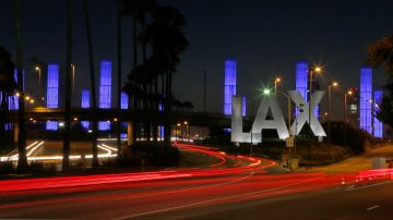 Lighted pylons at the Century Boulevard entrance to Los Angeles International Airport, which normally flash in a multicolored sequence, shine a steady blue Saturday evening, Nov. 2, 2013, in honor of Gerardo Hernandez, the Transportation Security Administration officer slain at an LAX terminal Friday. He is the first TSA officer to die in the line of duty in the history of the 12-year-old agency, created in the aftermath of the Sept. 11, 2001 terrorist attacks. (AP Photo/Reed Saxon)