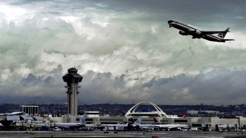 Under stormy skies in a break from rain that drenched the area overnight, an airplane takes off from Los Angeles International Airport Thursday, Jan. 11, 2001. Beginning Wednesday, drenching rain, hip-deep snow and towering waves clobbered California with the most powerful storm since destructive El Nino deluges three years ago. (AP Photo/Reed Saxon)