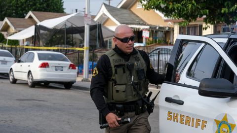 Authorities work on the scene after three young children were found dead in a bedroom at a residence in East Los Angeles, Monday, June 28, 2021. (AP Photo/Ringo H.W. Chiu)