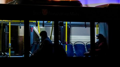 People wear face masks in a public bus in Frankfurt, Friday, Nov. 19, 2021. The government announced that the hospitalization rate will decide about further restrictions to avoid the outspread of the coronavirus. (AP Photo/Michael Probst)