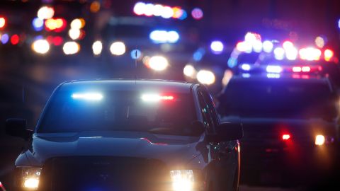 FILE - In this Friday, Dec. 4, 2015 file photo, police vehicles follow a hearse carrying slain University of Colorado-Colorado Springs Police Officer Garrett Swase to the Evergreen Cemetery in Colorado Springs, Colo. Swasey was one of three killed in a mass shooting at a nearby Planned Parenthood clinic. (AP Photo/David Zalubowski)