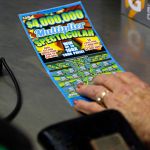 In this Thursday, July 17, 2014 photo, a woman purchases a scratch-off lottery ticket at Eagles Express in Knightdale, N.C. North Carolinas lottery has steadily grown over its first decade and its leaders say it has room to grow even more in the coming years. (AP Photo/Gerry Broome)