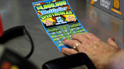 In this Thursday, July 17, 2014 photo, a woman purchases a scratch-off lottery ticket at Eagles Express in Knightdale, N.C. North Carolinas lottery has steadily grown over its first decade and its leaders say it has room to grow even more in the coming years. (AP Photo/Gerry Broome)