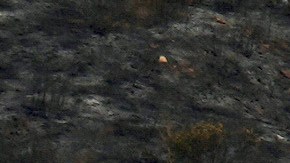 Water is dropped onto the Franklin Fire by helicopter, Wednesday, Dec. 11, 2024, in Malibu, Calif. (AP Photo/Eric Thayer)