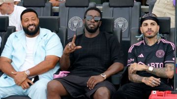 left, DJ Khaled, second from left, Diddy, and Rauw Alejandro, right, sit in a VIP area before a Leagues Cup match between Inter Miami and Atlanta United, Tuesday, July 25, 2023, in Fort Lauderdale, Fla. (AP Photo/Lynne Sladky)