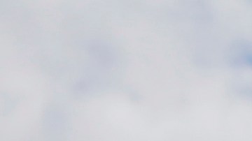 FILE - In this April 29, 2018, file photo, a drone operator helps to retrieve a drone after photographing over Hart Island in New York. (AP Photo/Seth Wenig, File)