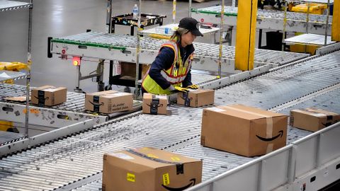 An Amazon employee puts packages on to a conveyor belt at an Amazon's DAX7 delivery station during Amazon's annual Prime Day event on Tuesday, July 16, 2024, in South Gate, Calif. (AP Photo/Richard Vogel)