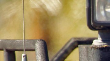 Los Angeles police SWAT Officers and Los Angeles County Sheriff's Special Enforcement Bureau work together to respond to the scene of a standoff in the Sylmar section of Los Angeles on Monday, April 4, 2011. Police blasted tear gas into a home and traded gunfire Monday with a man believed to have shot and critically wounded an officer during a nightlong standoff. The man remained barricaded in the Sylmar home for more than 12 hours as police and Los Angeles County sheriff's officers in armored vests and helmets surrounded the house.(AP Photo/Al Seib, Pool)