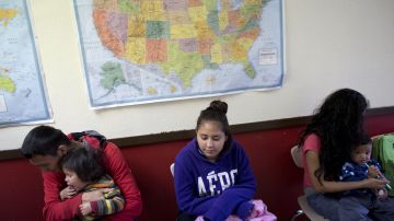 In this Jan. 5, 2016 photo, migrants wait in line to take a shower, as they sit by a U.S. map at a center that provides assistance to newly-arrived migrant families with children, at Sacred Heart Catholic Church in McAllen, Texas. ìWe must not be taken aback by their numbers, but rather view them as persons, seeing their faces and listening to their stories, trying to respond as best we can to their situation,î Pope Francis said in an address to the U.S. Congress. (AP Photo/Rebecca Blackwell)