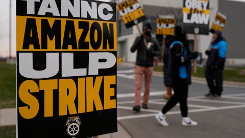 Strikers hold signs during a strike at Skokie (DIL7) Amazon Delivery station in Skokie, Ill., Thursday, Dec. 19, 2024. (AP Photo/Nam Y. Huh)