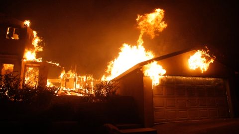 A house burns on Conejo Lane, ignited by a wind driven brush fire dubbed the "Tea Fire" in Montecito, Calif. on Thursday, Nov. 13, 2008. (AP Photo/Dan Steinberg)