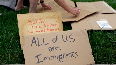 A woman makes a sign as protesters gather outside the Mexican Consulate, Friday, July 18, 2014, in Austin, Texas. Prospects for action on the U.S.-Mexico border crisis faded Thursday as lawmakers traded accusations rather than solutions, raising chances that Congress will go into its summer recess without doing anything about the tens of thousands of migrant children streaming into South Texas. (AP Photo/Eric Gay)