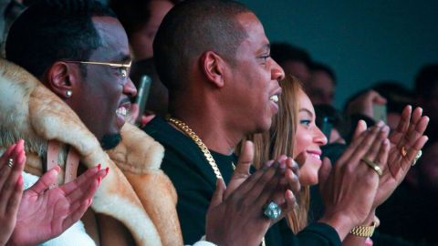 Sean Combs, from left, Jay Z, and Beyonce watch as Kanye West's Yeezy Boost shoe line for Adidas is shown during Fashion Week in New York on Thursday, Feb. 12, 2015. (AP Photo/Bebeto Matthews)