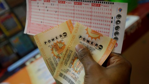 Duane Bouligny holds up Powerball tickets he purchased at Moza Easy Shop in San Francisco, Wednesday, Jan. 13, 2016. The Powerball jackpot for Wednesday night's drawing is at least $1.5 billion, the largest lottery jackpot in the world. (AP Photo/Jeff Chiu)