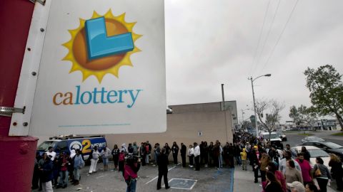 People line up to buy Mega Millions lottery tickets at the Bluebird Liquor store in Hawthorne, Calif. on Friday, March 30, 2012. Lottery ticket lines across the U.S. swelled Friday as players drawn by a record $640 million Mega Millions jackpot took a chance at becoming an overnight millionaire. (AP Photo/Damian Dovarganes)