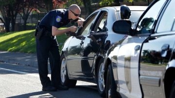 FILE - In this Nov. 12, 2012 file photo, a Sacramento Police Officer makes a traffic stop in Sacramento, Calif. The California Supreme Court is set to issue a ruling on police authority to conduct searches. The decision expected Monday, Dec. 5, 2016, will address police power to search people during traffic stops. At issue is whether police must first make an arrest for a traffic violation before conducting a search or can conduct a search beforehand as long as the person is later arrested, even for an unrelated crime. (AP Photo/Rich Pedroncelli, File)