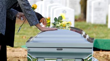 Family members place flowers on the casket containing the remains of Army Sgt. 1st Class Luis M. Gonzalez, of South Ozone Park, N.Y; Sgt. Dale R. Griffin, of Terre Haute, Ind.; Sgt. Isaac B. Jackson, of Plattsburg, Mo.; Sgt. Patrick O. Williamson, of Broussard, La..; Spc. Jared D. Stanker, of Evergreen Park, Ill.; Pfc. Christopher I. Walz, of Vancouver, Wash.; and Sgt. Fernando de la Rosa, of Alamo, Texas.; Thursday, Nov. 18, 2010, at Arlington National Cemetery in Arlington, Va. The group died by a roadside bomb, Oct. 27, 2009, southern Afghan province of Kandahar. (AP Photo/Jose Luis Magana)