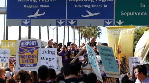 Union workers at Los Angeles International Airport gather near the airport during a protest in Los Angeles, Wednesday, Nov. 21, 2012. Hundreds of union members marched Wednesday near the entrance to Los Angeles International Airport, where Thanksgiving travelers were warned to arrive early in case of traffic snarls. (AP Photo/Jae C. Hong)