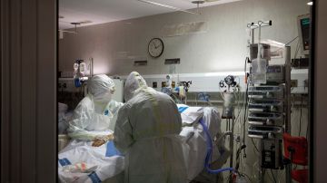 In this photo taken on Friday, March 27, 2020, healthcare workers assist a patience at one of the intensive care units (ICU) at German Trias i Pujol hospital in Badalona, in the Barcelona province, Spain. The new coronavirus causes mild or moderate symptoms for most people, but for some, especially older adults and people with existing health problems, it can cause more severe illness or death. (AP Photo/Anna Surinyach)