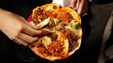 A woman holds a plate that include tacos al pastor and alambre at the inauguration of the Tlalpan Taco Fair featuring 20 different tacos, in Mexico City, Saturday, June 15, 2013. (AP Photo/Ivan Pierre Aguirre)(AP Photo/Ivan Pierre Aguirre)