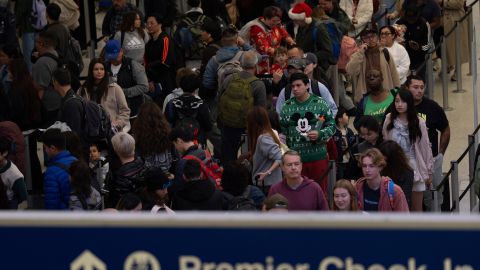 Travelers wait in line for security checks at the Los Angeles International Airport in Los Angeles, Tuesday, Dec. 24, 2024. (AP Photo/Jae C. Hong)