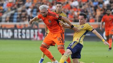 Houston Dynamo midfielder Héctor Herrera (16) has the ball knocked away by Real Salt Lake defender Bryan Oviedo (3) during the first half of an MLS playoff soccer match, Sunday, Oct. 29, 2023, in Houston. (AP Photo/Kevin M. Cox)