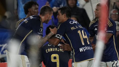 Juan Carvajal of Colombia's Millonarios celebrates with teammates after scoring the opening goal in a Copa Libertadores Group E soccer match against Chile's Palestino at El Campin stadium in Bogota, Colombia, Tuesday, May 14, 2024. (AP Photo/Fernando Vergara)