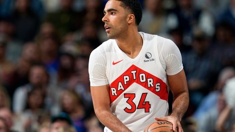 FILE - Toronto Raptors center Jontay Porter (34) looks to pass in the first half of an NBA basketball game Monday, March 11, 2024, in Denver. Court papers indicate that former Toronto Raptors player Jontay Porter will be charged with a federal felony connected to the sports betting scandal that spurred the NBA to ban him for life.