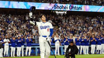 FILE - Los Angeles Dodgers designated hitter Shohei Ohtani (17) is honored for being first MLB player to achieve 50 home runs and 50 stolen bases in a single season during the first inning of a baseball game against the Colorado Rockies in Los Angeles, Friday, Sept. 20, 2024. (AP Photo/Ashley Landis, File)