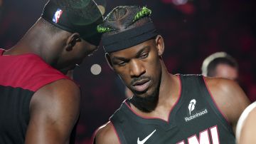 Miami Heat forward Jimmy Butler (22) and center Bam Adebayo, left, are introduced before an NBA basketball game against the Indiana Pacers Thursday, Jan. 2, 2025, in Miami. (AP Photo/Lynne Sladky)