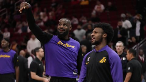 Los Angeles Lakers forward LeBron James, left, and guard Bronny James Jr. warm up before an NBA basketball game against the Houston Rockets in Houston, Sunday, Jan. 5, 2025. (AP Photo/Ashley Landis)