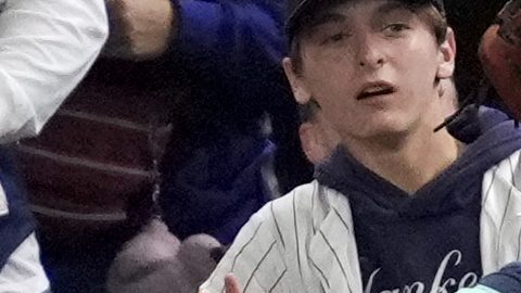 FILE - Fans interfere with a foul ball caught by Los Angeles Dodgers right fielder Mookie Betts during the first inning in Game 4 of the baseball World Series against the New York Yankees, Tuesday, Oct. 29, 2024, in New York. (AP Photo/Ashley Landis, File)