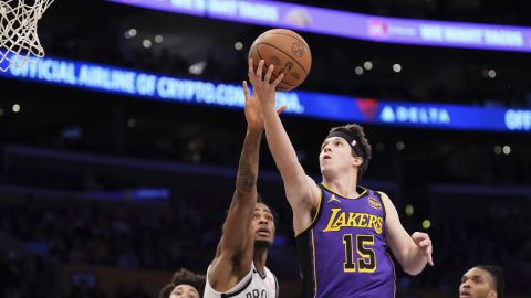 Los Angeles Lakers guard Austin Reaves (15) shoots as Brooklyn Nets center Nic Claxton (33) defends during the first half of an NBA basketball game, Friday, Jan. 17, 2025, in Los Angeles. (AP Photo/Mark J. Terrill)