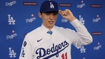 Japanese right-hander pitcher Roki Sasaki, 23, poses as he is introduced by the Los Angeles Dodgers at a news conference at Dodger Stadium Wednesday, Jan. 22, 2025 in Los Angeles. (AP Photo/Damian Dovarganes)